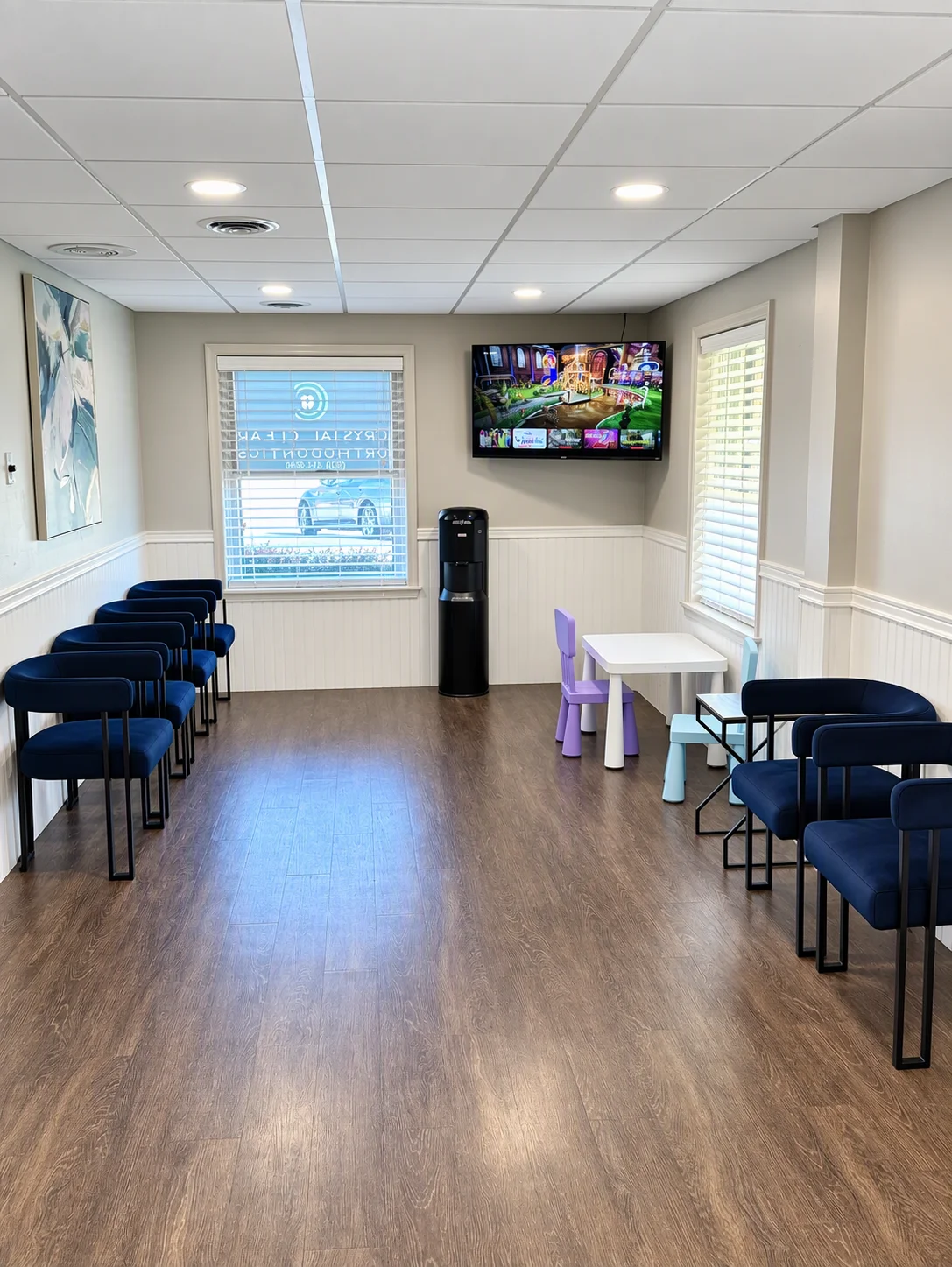 Waiting room at Crystal Clear Orthodontics & Pediatric Dentistry with seating and a kids' play table